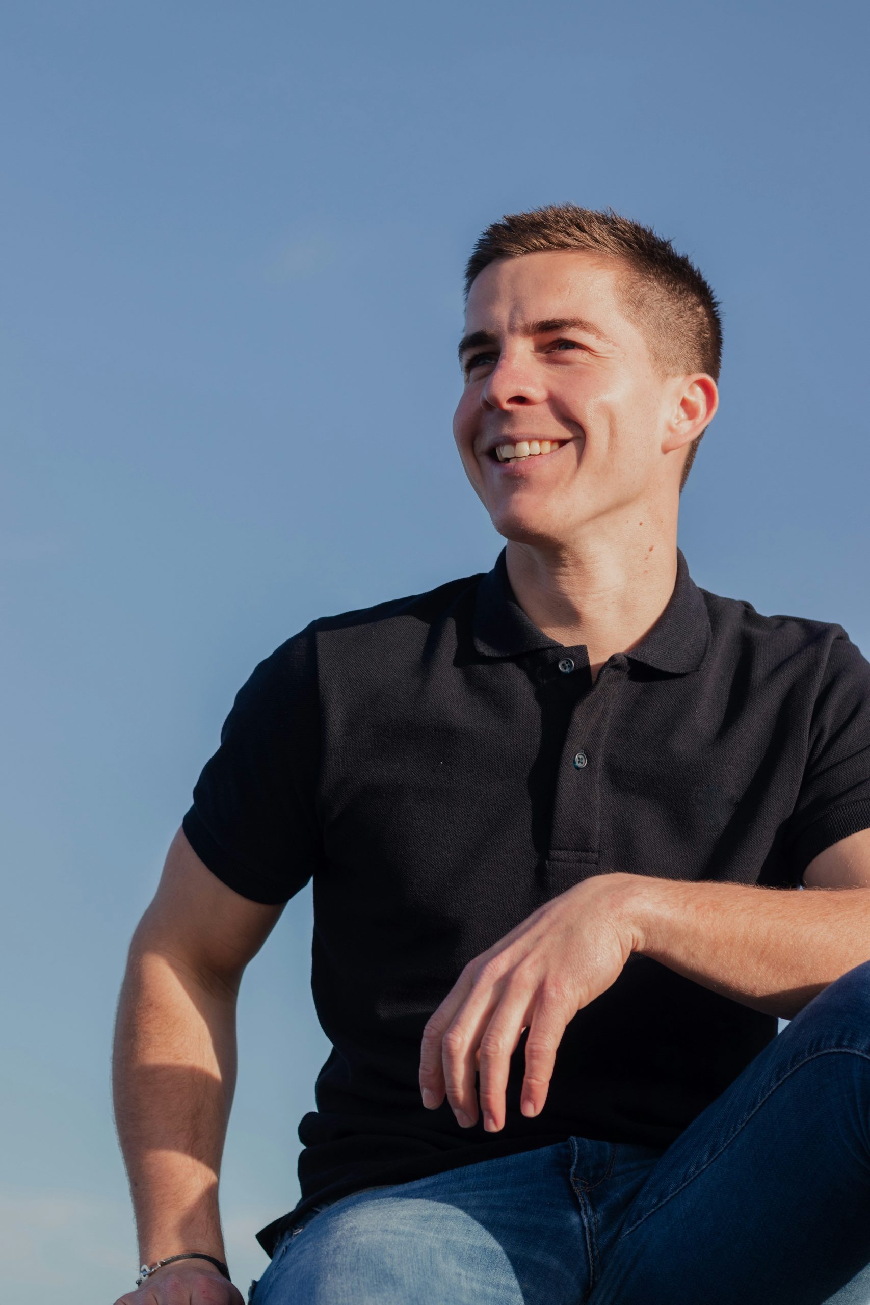 Black polo shirt with blue jeans